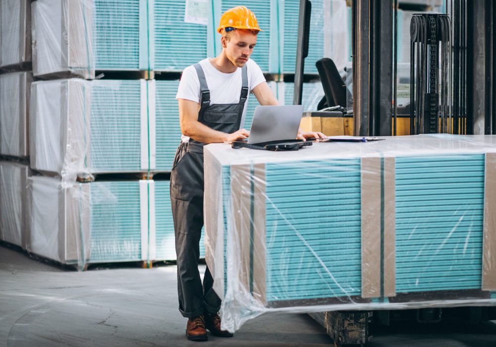 Young man working at a warehouse with boxes