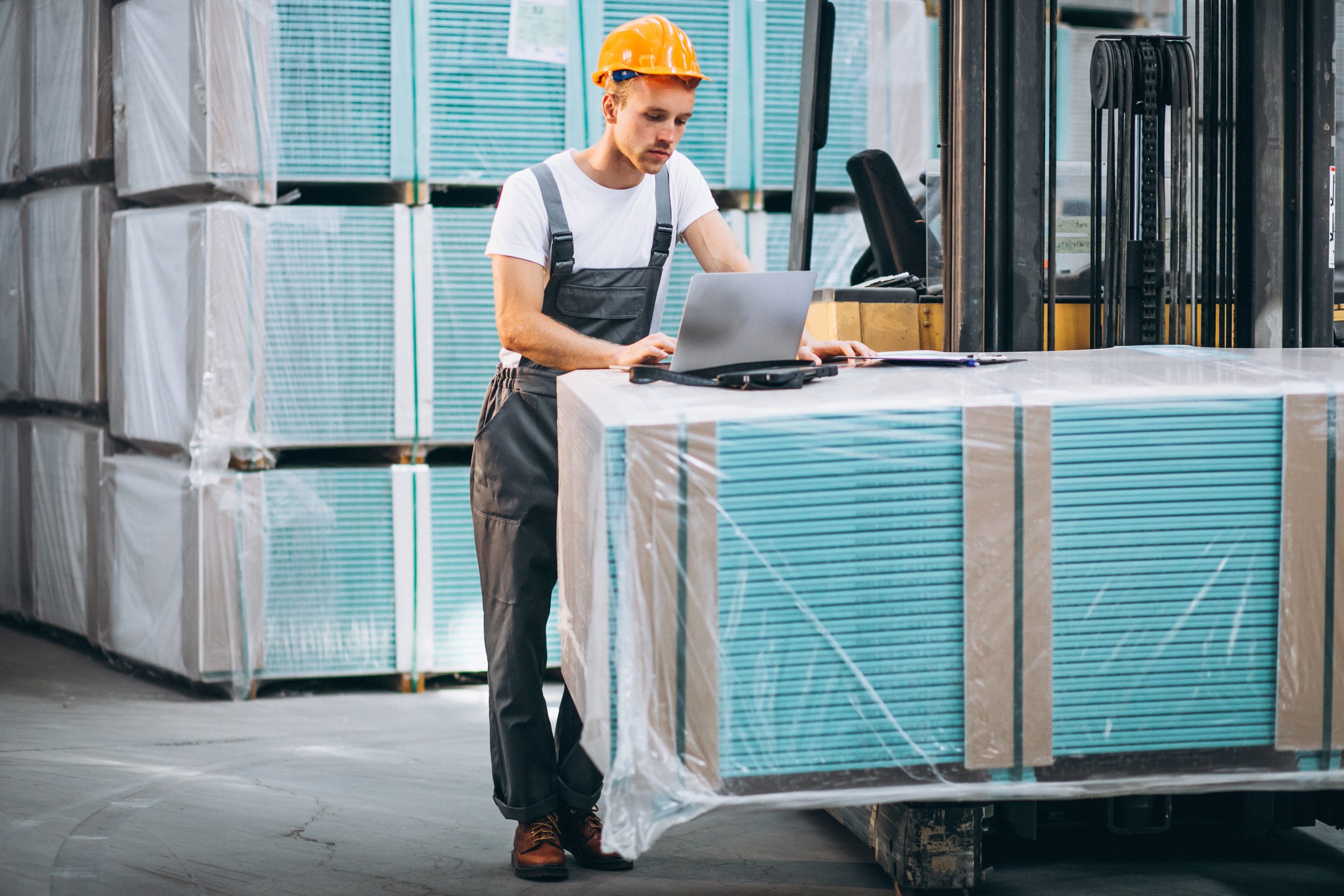 Young man working at a warehouse with boxes